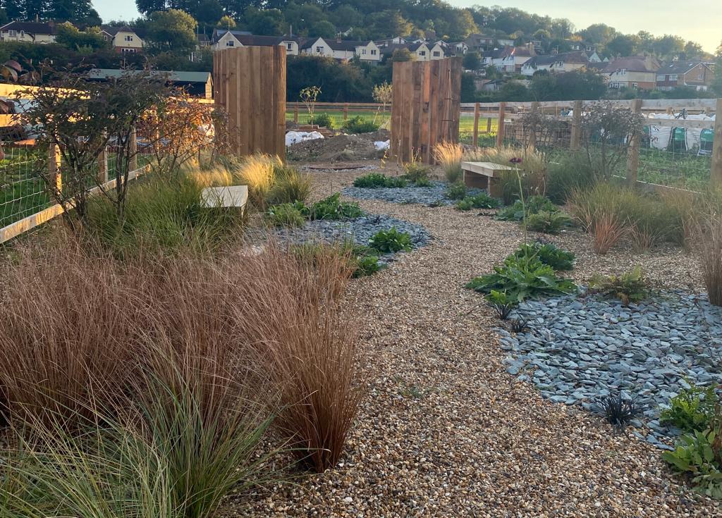 The Miner’s Retreat rustic garden planting with stone